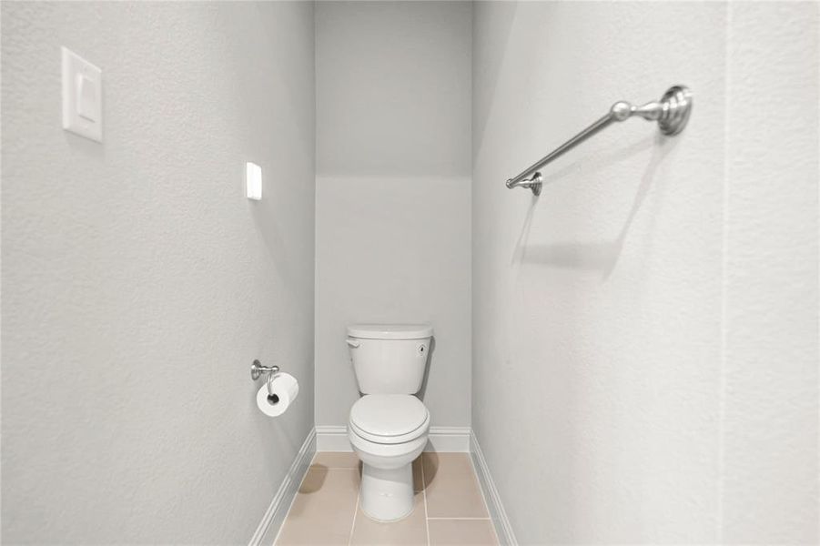 Bathroom with tile patterned flooring and toilet Bathroom with tile patterned flooring and toilet