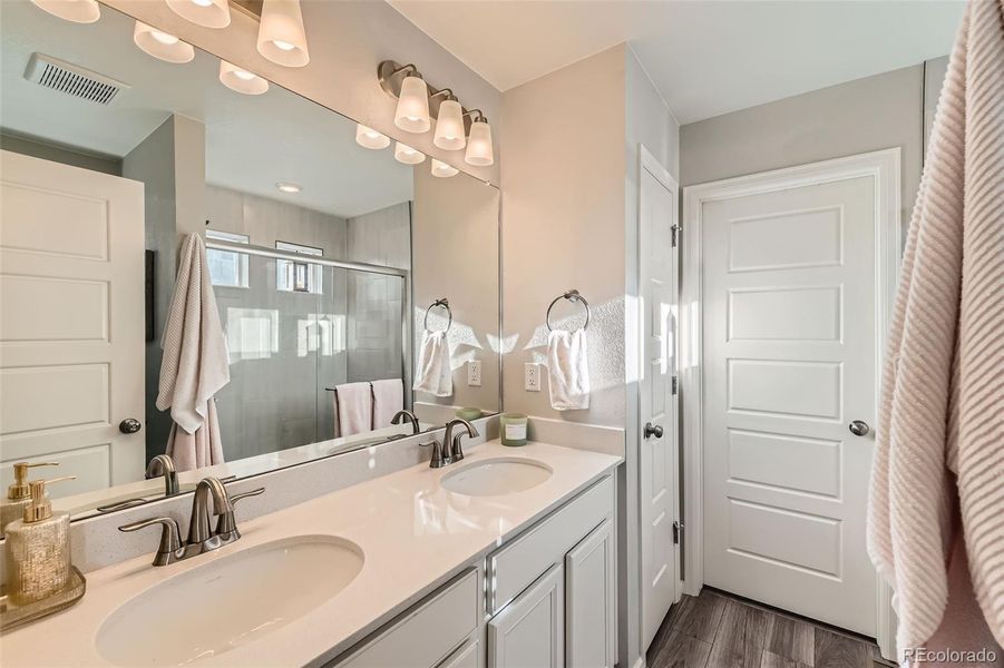 Double quartz vanity with walk-in shower and closet