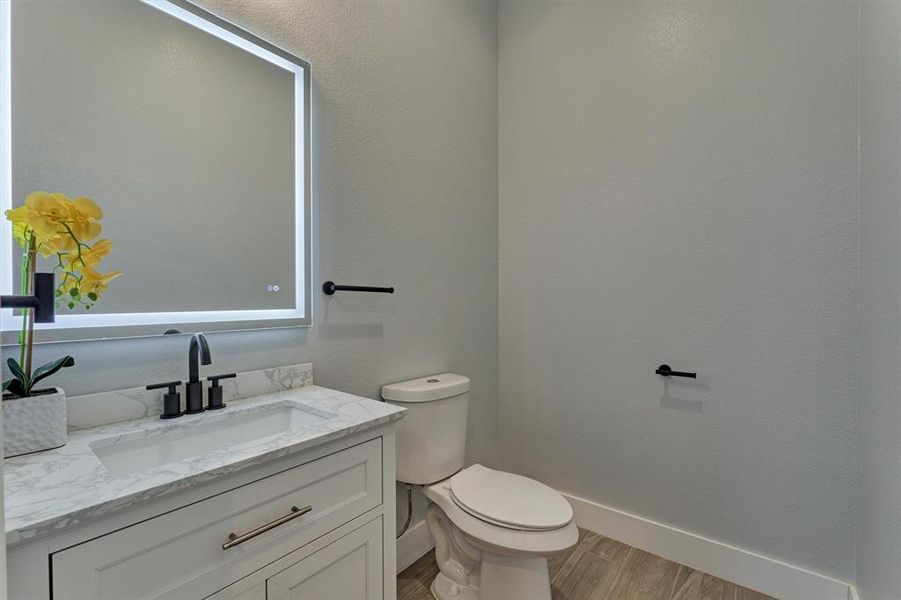 First floor powder room with LED touch mirror.