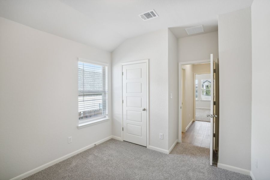 Guest bedroom in the Callaghan floorplan at a Meritage Homes community.