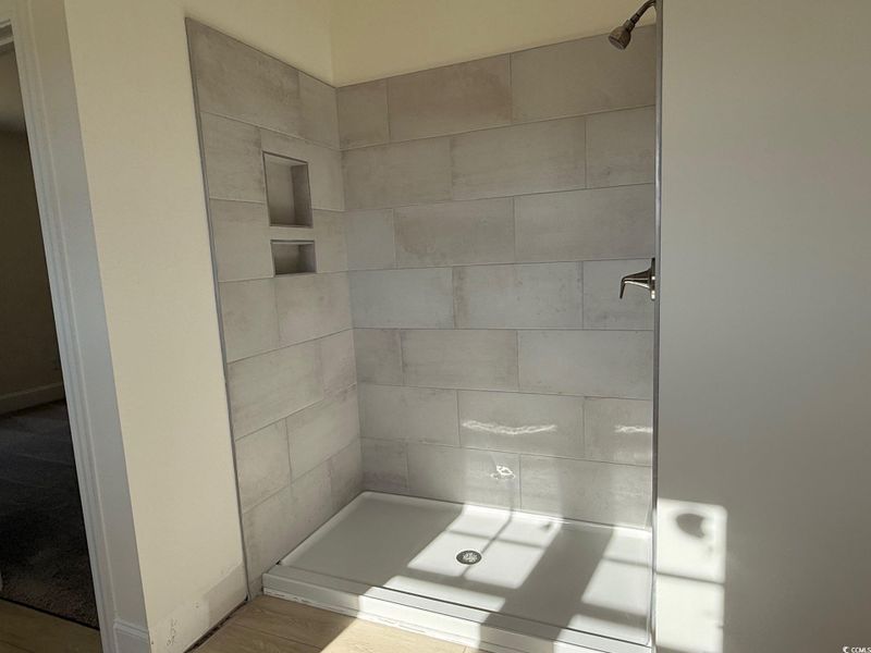 Owner's bath with divided double vanity, tile shower & soaking tub.