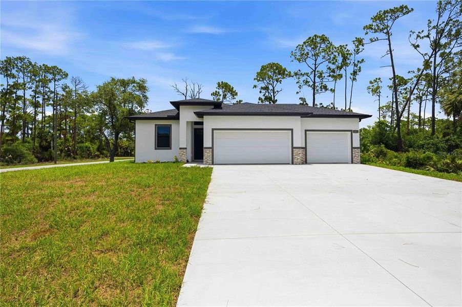 Front exterior of a new home in , Port Charlotte, FL, highlighting curb appeal (Image 2). Front exterior of a new home in , Port Charlotte, FL, highlighting curb appeal (Image 2).