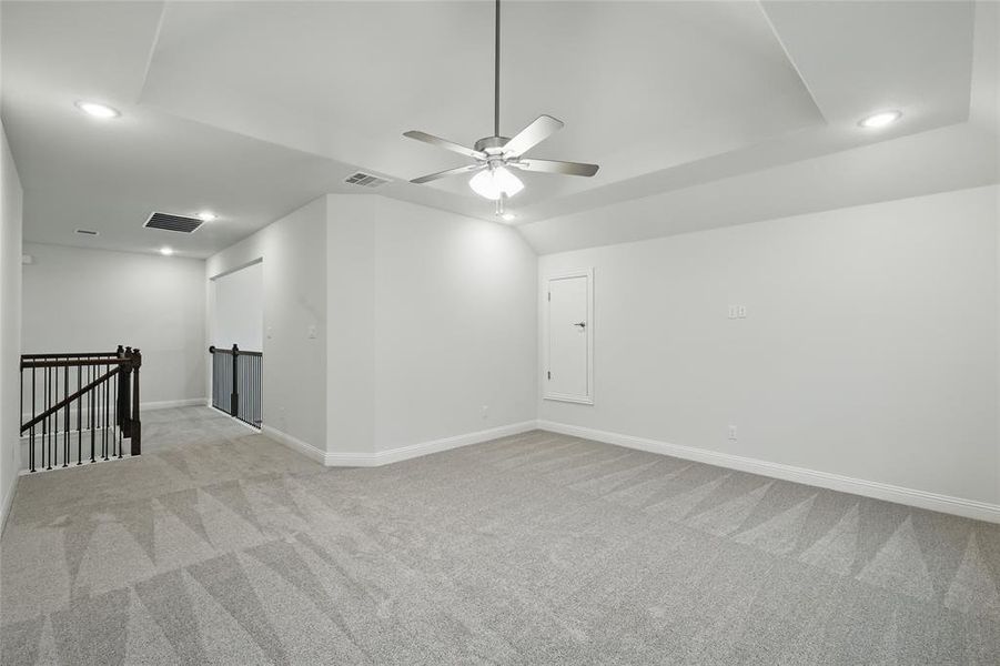 Empty room featuring light carpet, recessed lighting, baseboards, and a ceiling fan