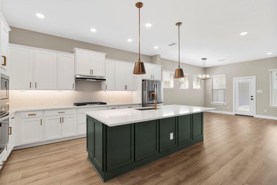 Kitchen opens to living and dining spaces