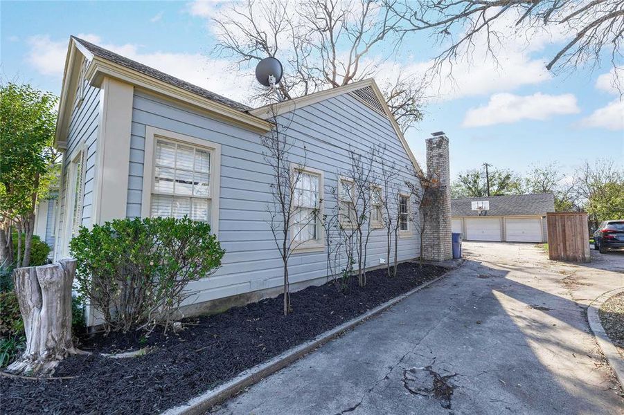 Side of house with shared driveway and landscaping