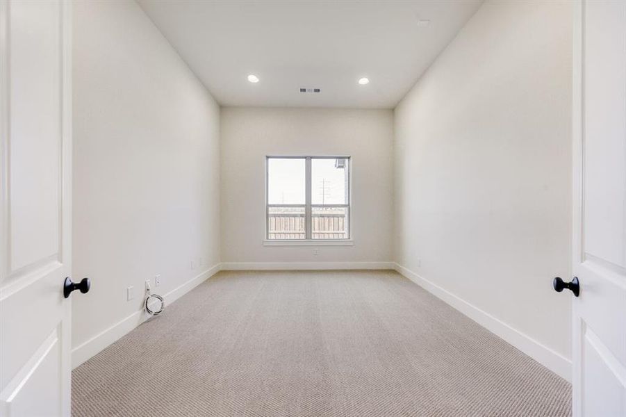 Empty room featuring light carpet and recessed lighting