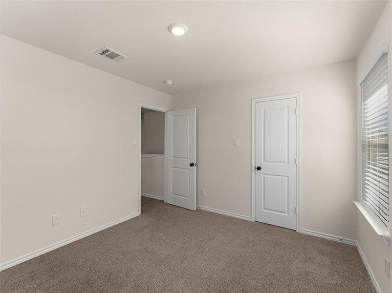 Unfurnished bedroom with carpet flooring