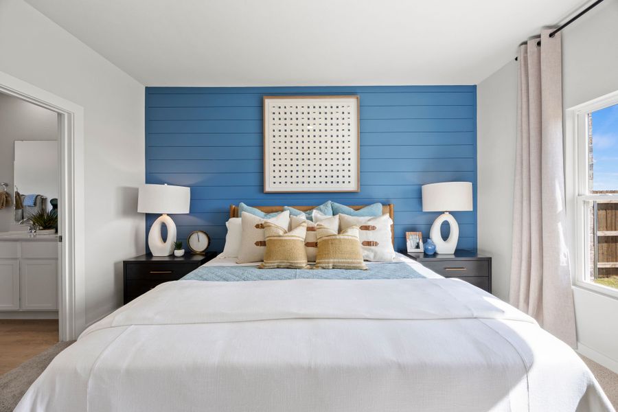 A bedroom with a blue wall.