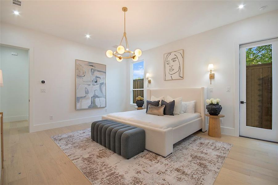 Bedroom with light wood finished floors, recessed lighting, and a chandelier Bedroom with light wood finished floors, recessed lighting, and a chandelier
