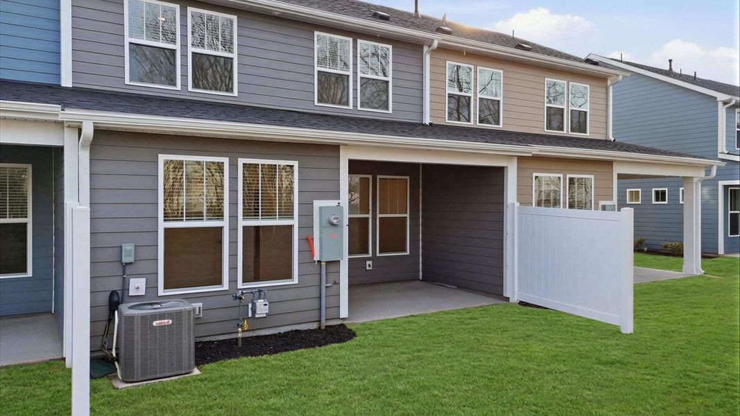 Rear covered porch creates a seamless extension of this home’s elegant design