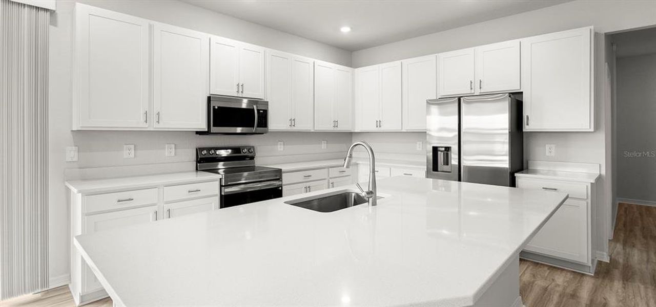 Furnished interior view inside a new home in Estates at Hickory Cove - Bungalows, St. Cloud (Image 9).