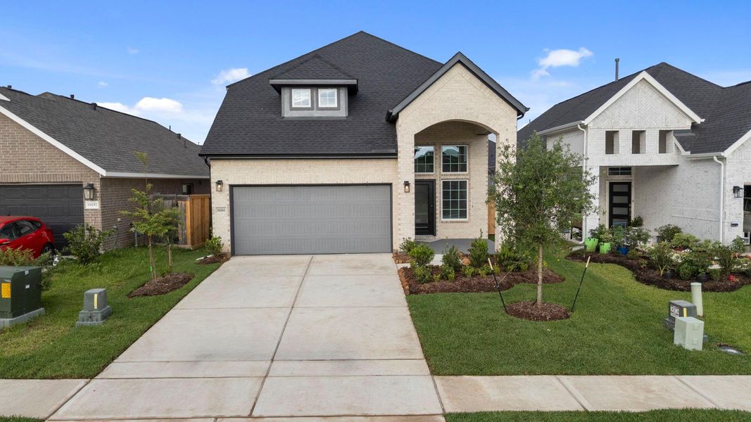 Front exterior of a new home in Emory Glen, Magnolia, TX, highlighting curb appeal (Image 21).