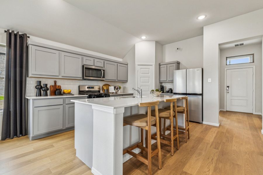 Kitchen in the Turquoise home plan by Trophy Signature Homes – REPRESENTATIVE PHOTO