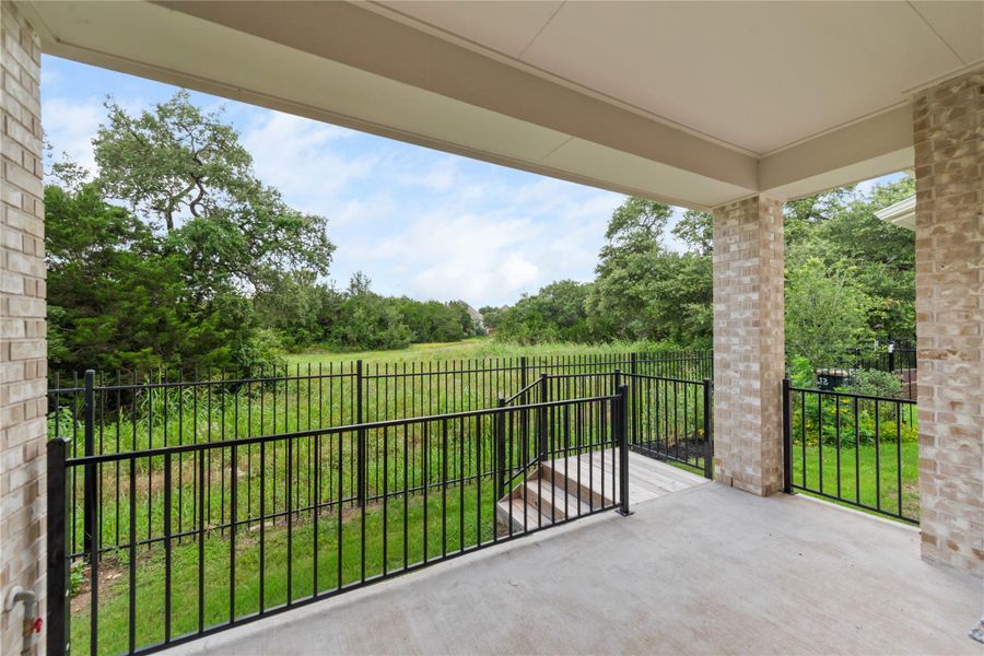 A spacious covered patio offers sweeping views of the verdant yard and natural surroundings. A spacious covered patio offers sweeping views of the verdant yard and natural surroundings.