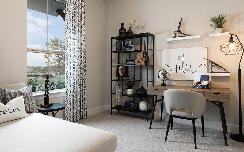 Bedroom featuring light colored carpet and an office area Bedroom featuring light colored carpet and an office area