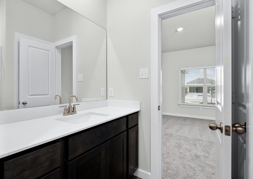 The master bathroom has a sprawling vanity.