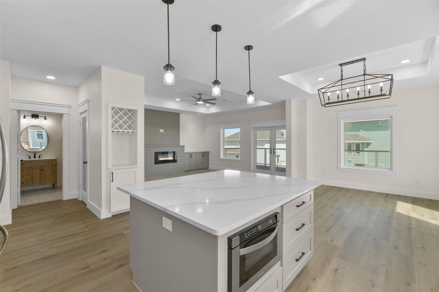 The open-concept kitchen, complete with a walk-in pantry and built-in wine storage, flows into the living and dining area. The open-concept kitchen, complete with a walk-in pantry and built-in wine storage, flows into the living and dining area.