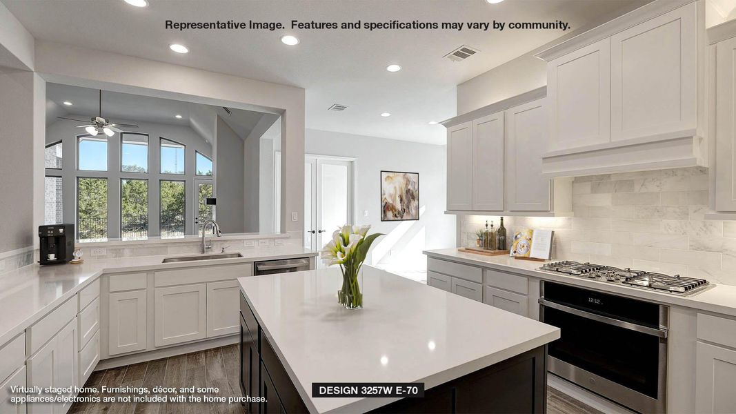 Kitchen with backsplash, appliances with stainless steel finishes, dark cabinets, white cabinets, and recessed lighting Kitchen with backsplash, appliances with stainless steel finishes, dark cabinets, white cabinets, and recessed lighting