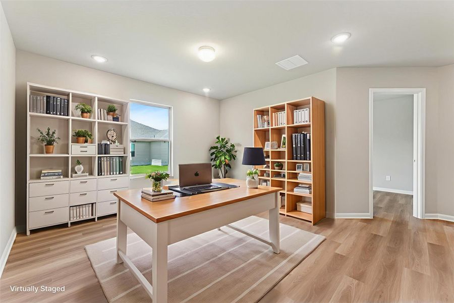 A well-lit study with ample shelving and a dedicated workspace provides a serene environment for productivity.
