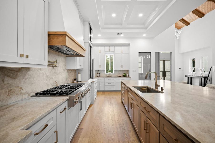 Custom vent hood and full-height backsplash complete the timeless design.