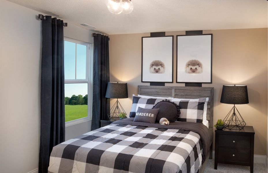 Secondary Bedroom with plush carpet flooring