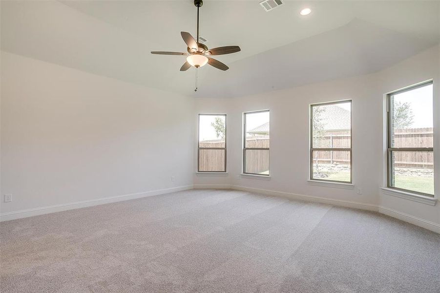 Carpeted empty room featuring ceiling fan