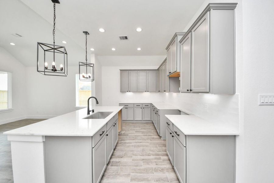 The kitchen is a culinary haven, featuring granite countertops, a tile backsplash, stainless steel appliances, 42” upper cabinets, and undercabinet lighting. The kitchen is a culinary haven, featuring granite countertops, a tile backsplash, stainless steel appliances, 42” upper cabinets, and undercabinet lighting.