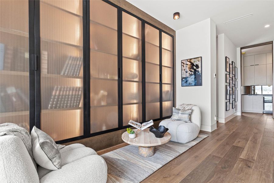 Built-in cabinetry with fluted glass panels and integrated lighting