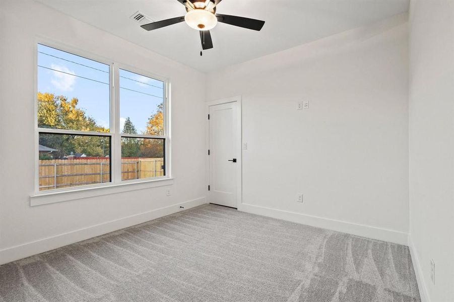 Spare room with light colored carpet and ceiling fan