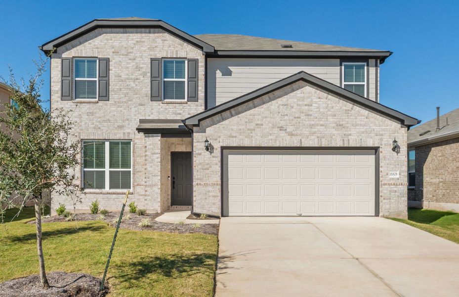 Front exterior of a new home in Lagos, Manor, TX, highlighting curb appeal (Image 16). Front exterior of a new home in Lagos, Manor, TX, highlighting curb appeal (Image 16).