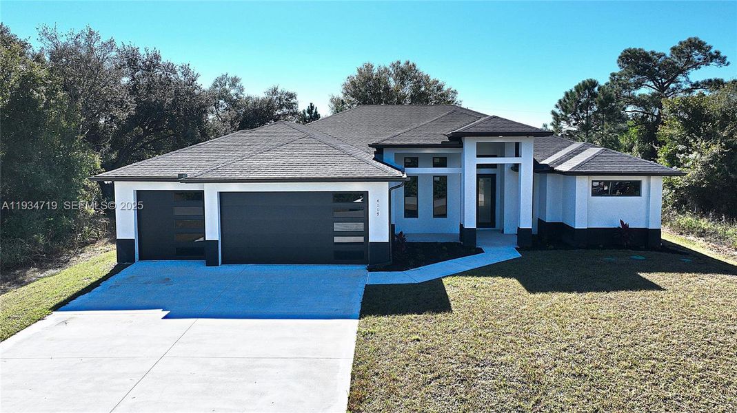 Front exterior of a new home in , Lehigh Acres, FL, highlighting curb appeal (Image 32).