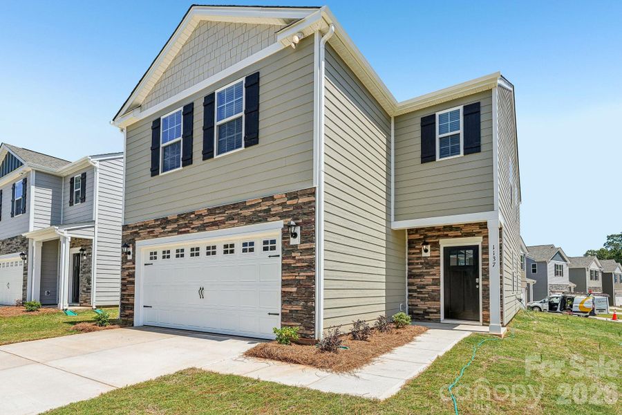 Front exterior of a new home in Fergus Crossing, York, SC, highlighting curb appeal (Image 16). Front exterior of a new home in Fergus Crossing, York, SC, highlighting curb appeal (Image 16).