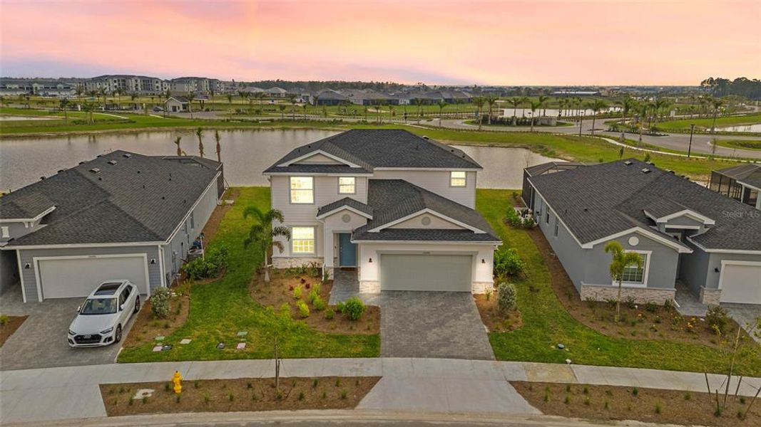Front exterior of a new home in Tuckers Cove: Villas, Punta Gorda, FL, highlighting curb appeal (Image 2).