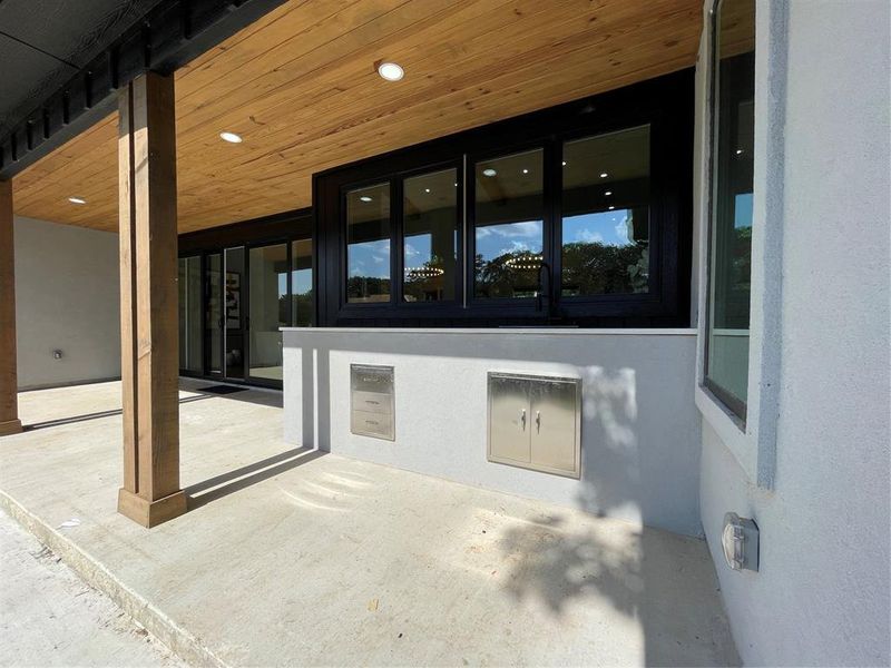 Sink with stainless storage, quartz counter tops. Windows off kitchen open for pass through