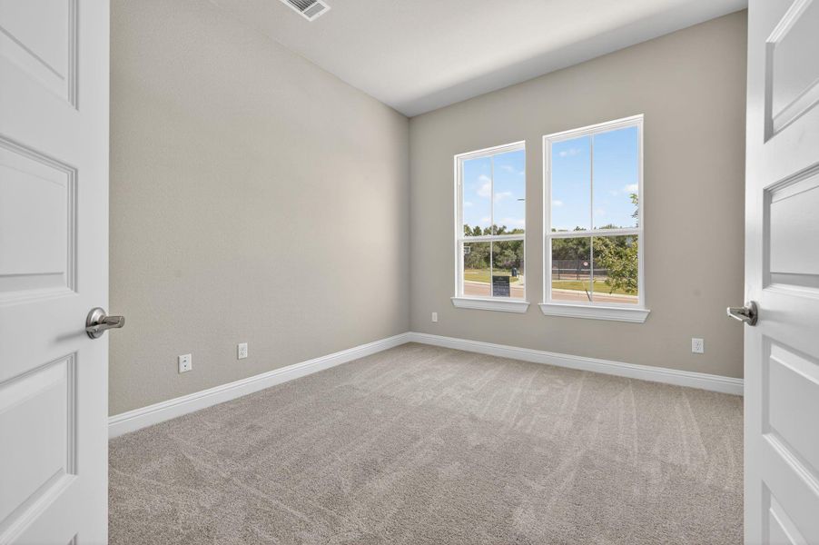 Unfurnished room featuring light carpet
