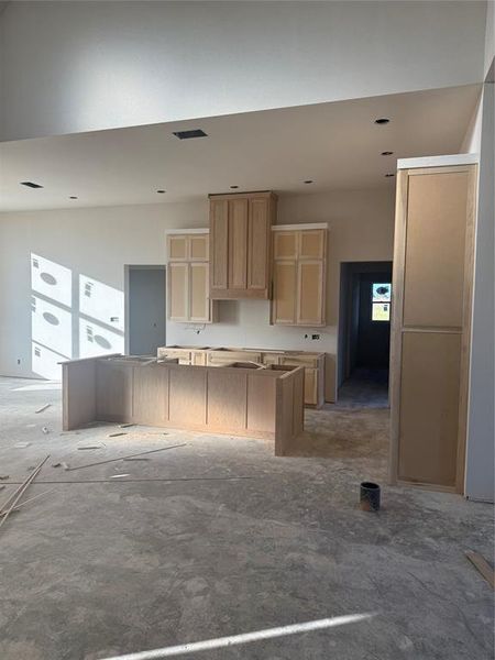 Kitchen featuring light brown cabinets and a kitchen island