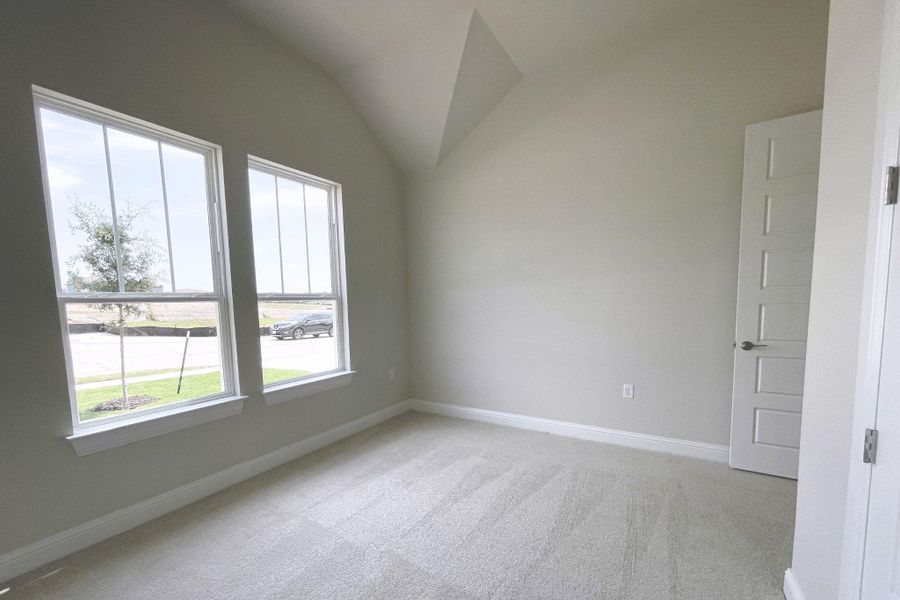 Natural light pours into this cozy room through well-placed windows.