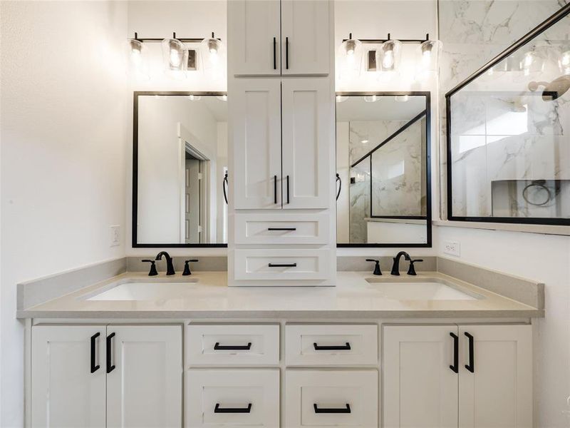 Dual vanities with sinks and built-in linen cabinets Dual vanities with sinks and built-in linen cabinets