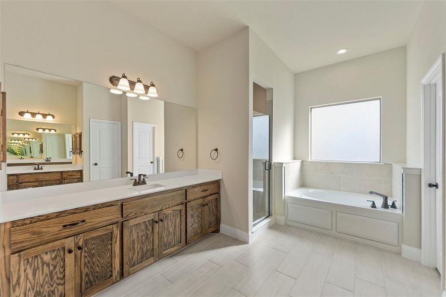 Bathroom with vanity and shower with separate bathtub