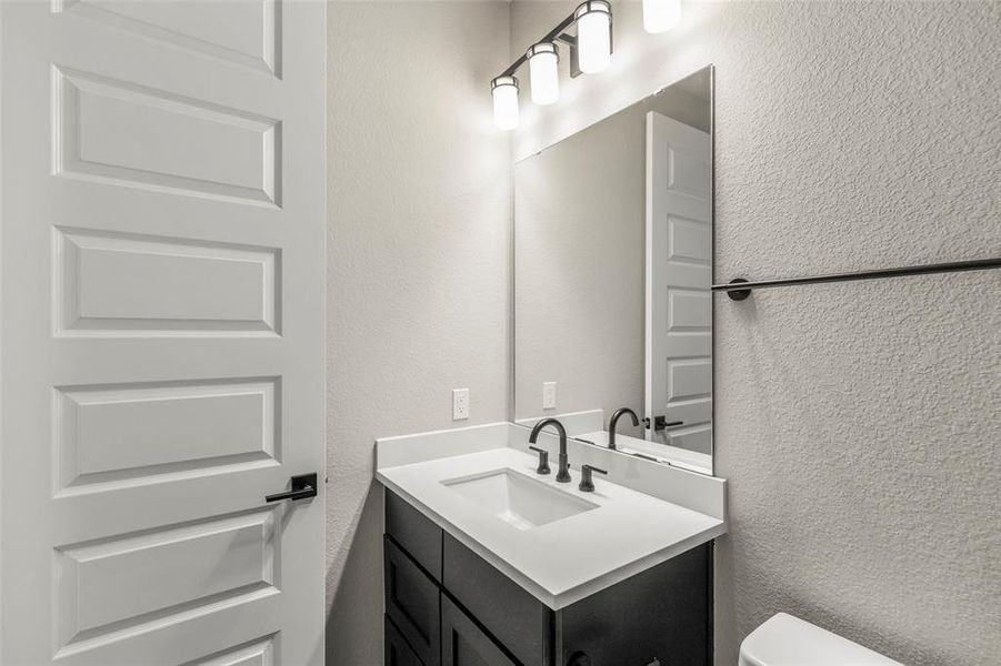 Beautiful Quartz Countertops and Fixture in this Bathroom