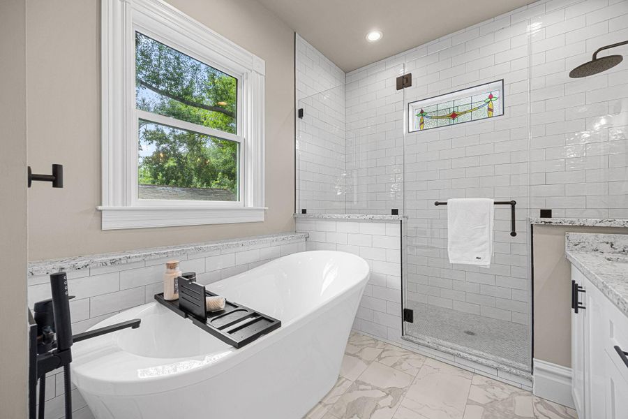 Oversized shower with frameless glass surround, and free-standing tub perfect for soaking. Oversized shower with frameless glass surround, and free-standing tub perfect for soaking.