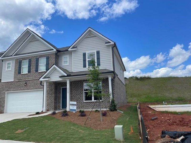 Front exterior of a new home in Alcovy Village, Lawrenceville, GA, highlighting curb appeal (Image 1).