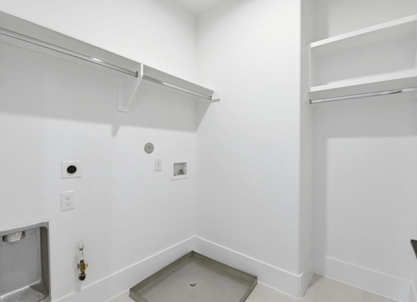 Convenient laundry room withbuilt-in shelving and additionalstorage space. (Photo of a previous build, similar finishes.)