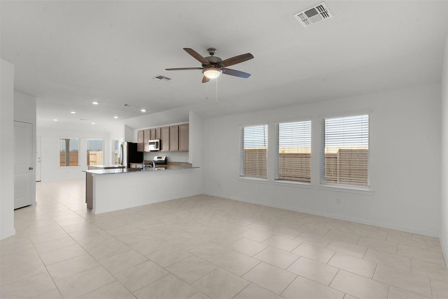 Unfurnished living room with ceiling fan, plenty of natural light, light tile patterned floors, and recessed lighting