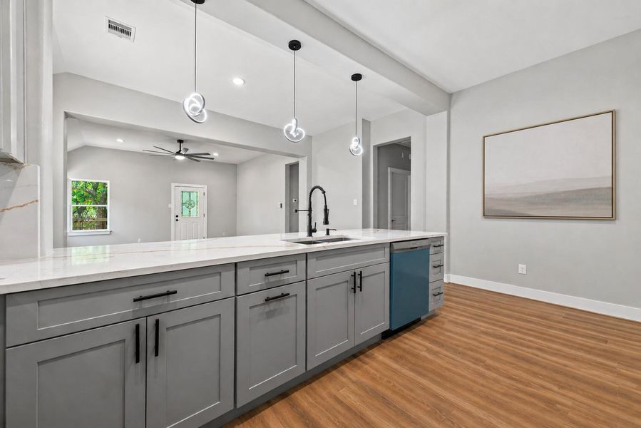 Thoughtfully designed kitchen featuring a large island, ample cabinetry, and an open flow to the main living areas.
