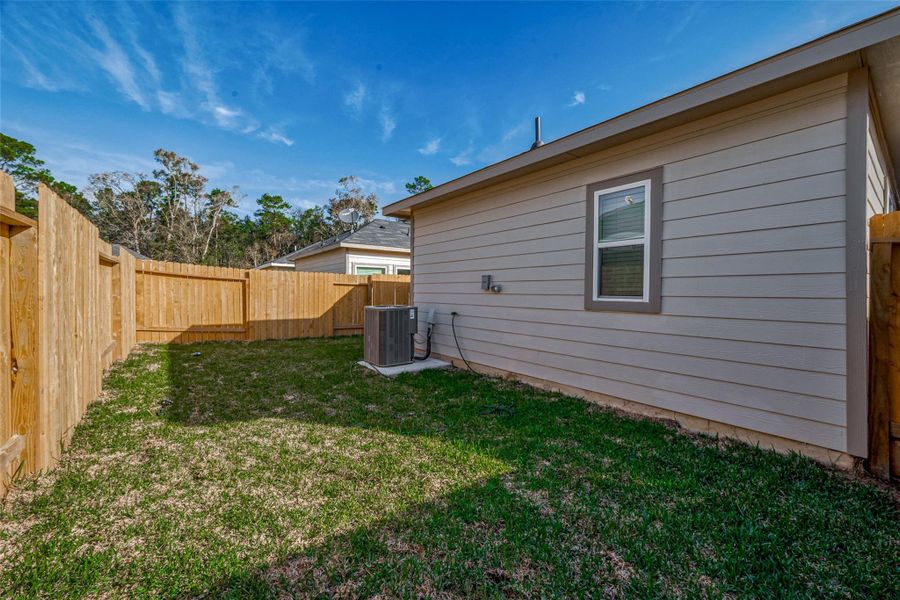 Exterior details and patio area of a home in Woodland Lakes, Huffman (Image 21).