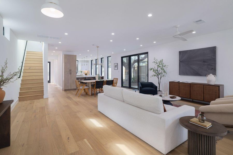 Living room featuring light wood finished floors and recessed lighting