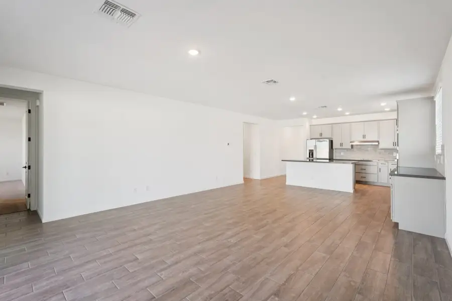 Great room, dining and kitchen. Finishes may vary by community.