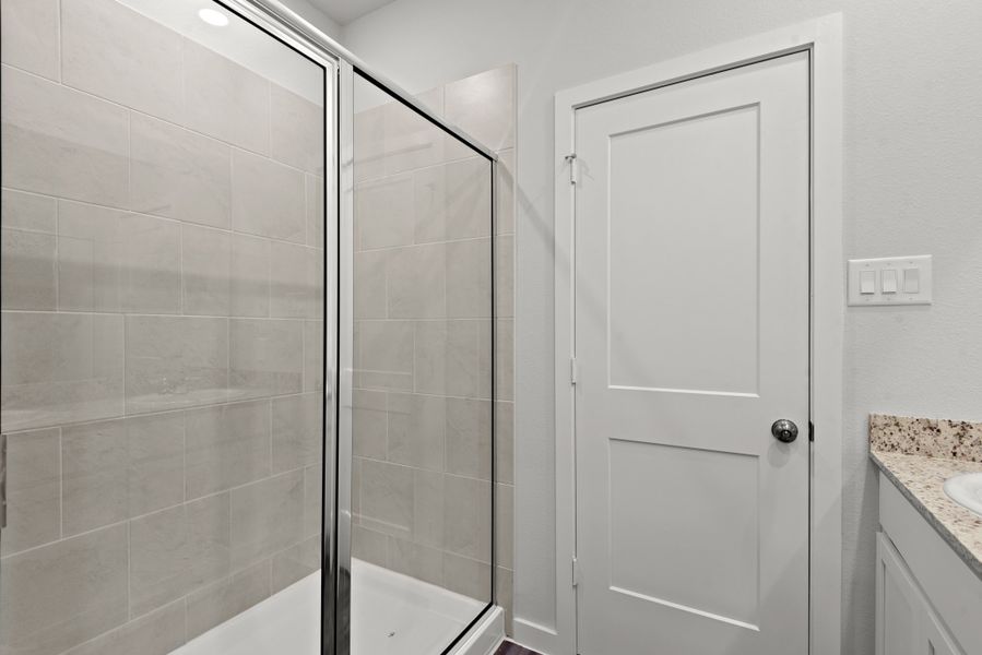 A bathroom with a glass shower. A bathroom with a glass shower.