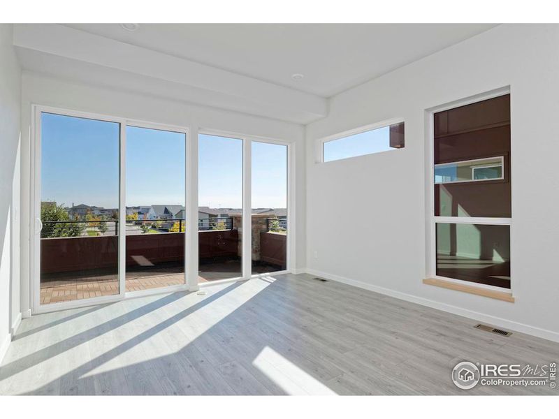 Living Area with sliding glass door and large windows to the east